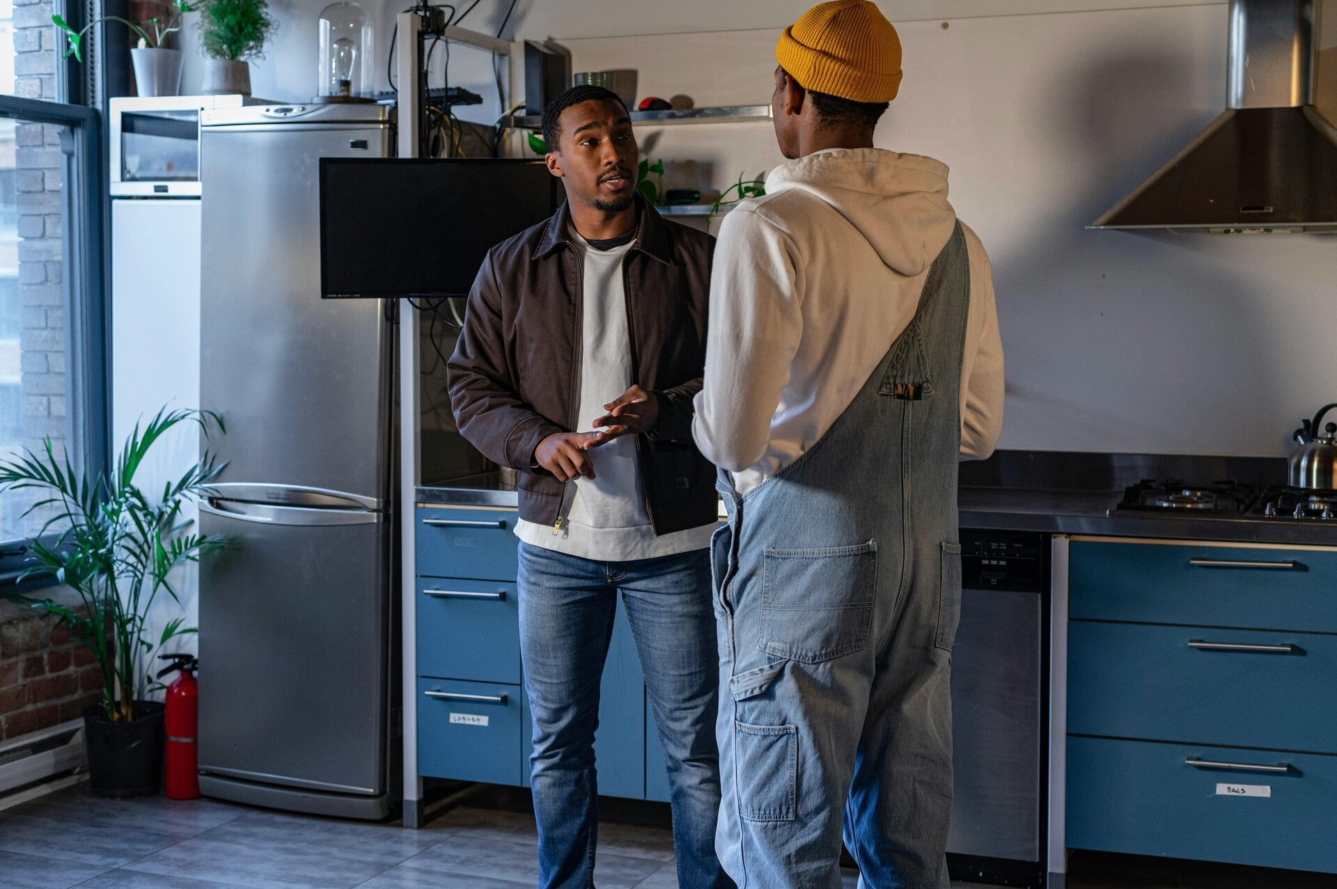 X.Q Electrical electrician talking through a job with a Doncaster customer in their kitchen